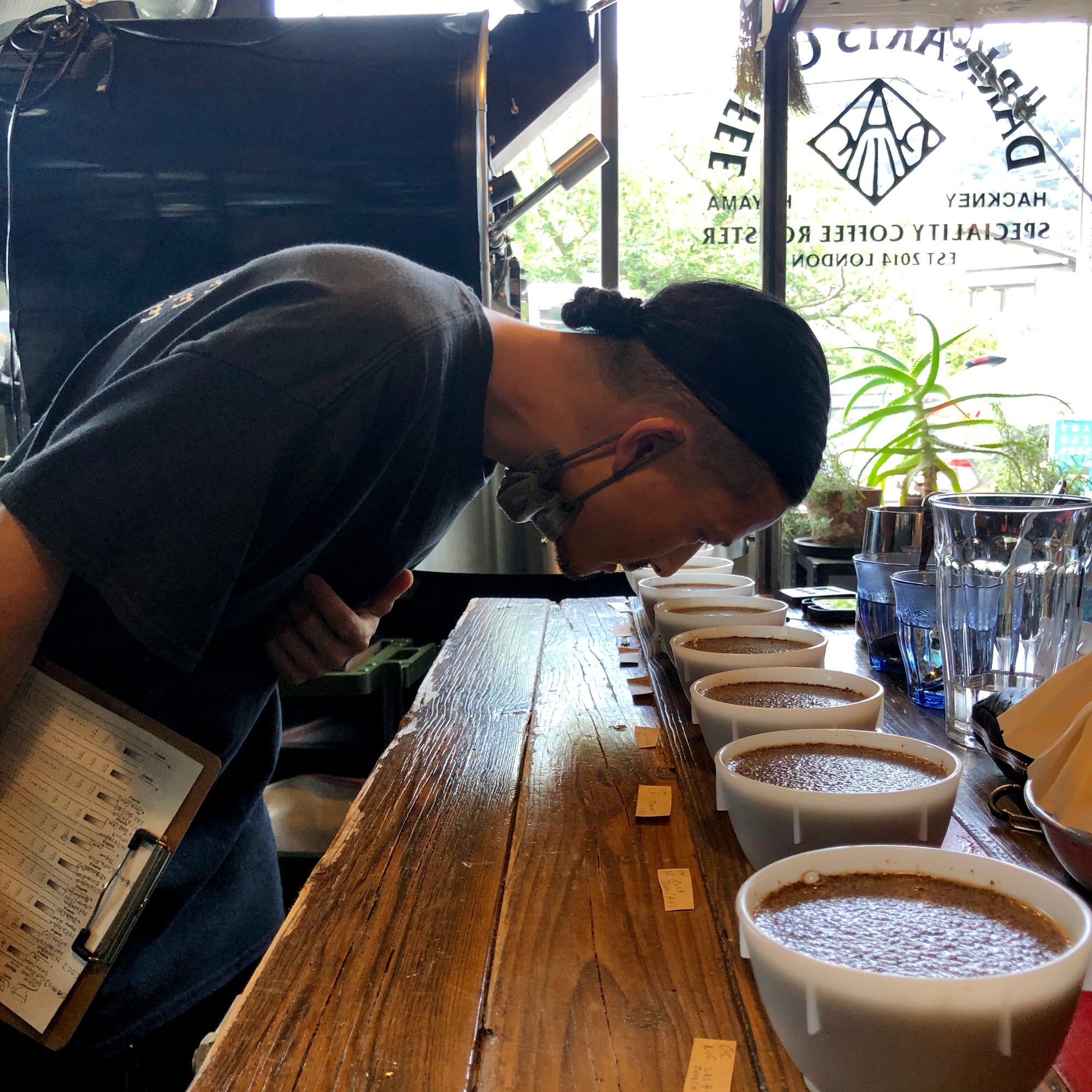 Young man cupping delicious looking specialty, single origin coffees from Dark Arts Coffee, Hayama, Kanagawa, Japan 